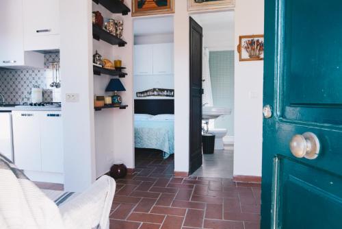 a kitchen with a blue door and a bedroom at La Torretta in Lerici