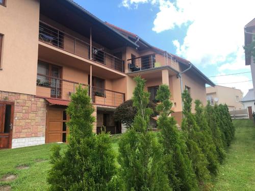 an apartment building with trees in front of it at Ladislav in Spišské Vlachy