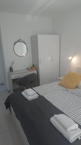 a bedroom with a bed with two towels on it at Apartments Nina in Rab