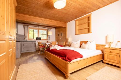 a bedroom with a large bed and a table at Bergwald Appartements Alpbach in Alpbach
