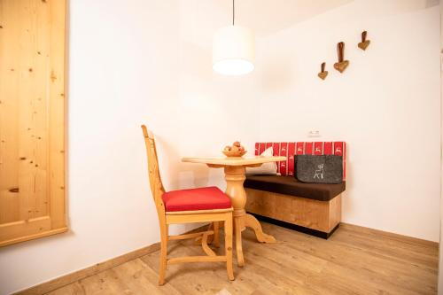 a table and a chair in a room at Bergwald Appartements Alpbach in Alpbach