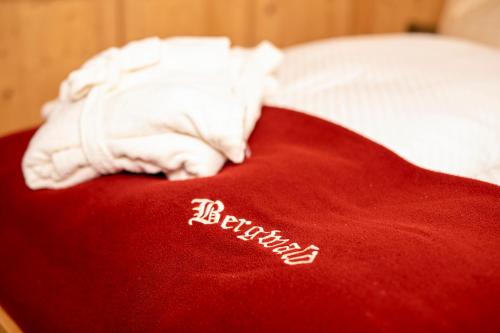 a red blanket with the word liberalism written on it at Bergwald Appartements Alpbach in Alpbach