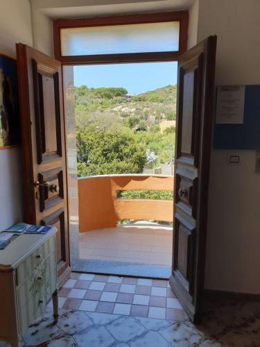 an open door in a room with a view at Guest House Tra Rocce E Mare in La Maddalena