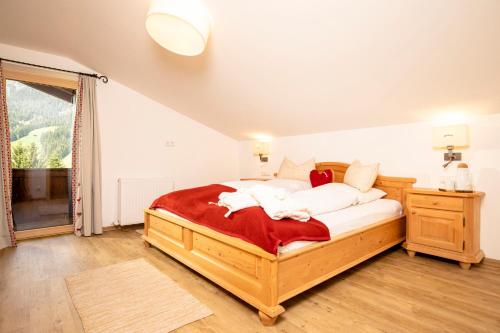 a bedroom with a bed with white pillows on it at Bergwald Appartements Alpbach in Alpbach