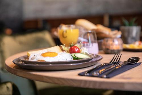 a plate of eggs and vegetables on a table at Hotel 46 in Wintelre