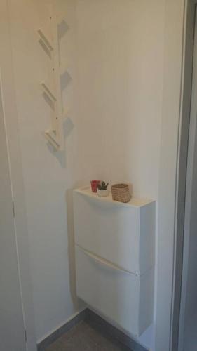 a white dresser in a room with a wall at Apartments Nina in Rab