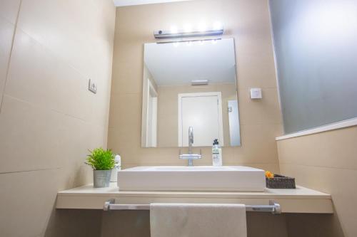 a bathroom with a sink and a large mirror at Don Moustache Boutique Hostel in Barcelona