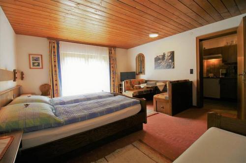 a bedroom with a bed and a window in a room at Haus Simone - Tschofen Waltraud in Sankt Gallenkirch