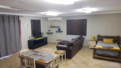 a living room with a couch and a table at LE -DANTE in Klerksdorp