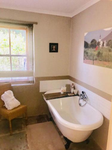 a bathroom with a white tub in a room at The Ibis Lounge in Nieu-Bethesda