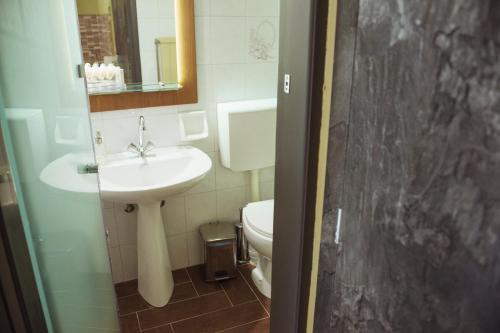 a bathroom with a sink and a toilet at La Luna in Kala Nera