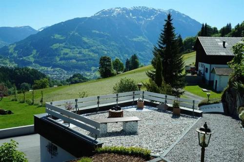 a bench sitting on top of a hill with a mountain at Ferienhaus Klaas in Schruns-Tschagguns