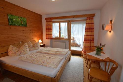 a bedroom with a large bed and a window at Haus Marent in Bartholomäberg