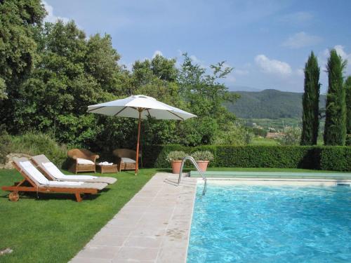 een zwembad met een parasol en stoelen en een tafel en een parasol bij Countryhouse with Pool in Vaison la Romaine in Vaison-la-Romaine