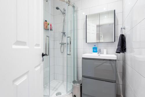 a bathroom with a shower and a sink at Camden Apartment A/Apartment in London