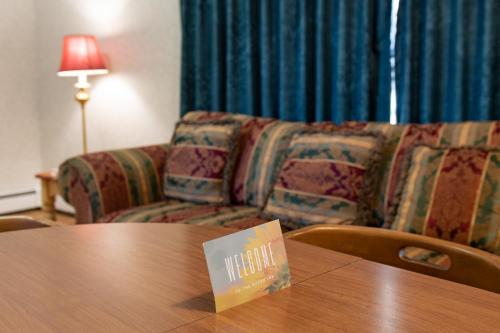 a table in a hotel room with a couch at Dutch Inn in Cornwall