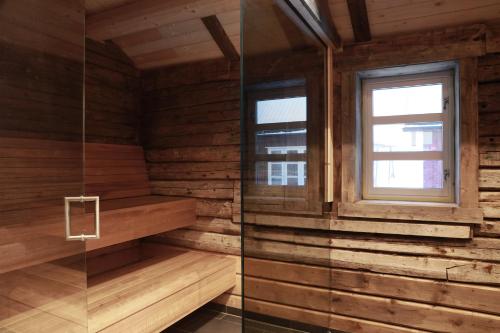 a sauna with wooden walls and a window at Solsiden Brygge Rorbuer in Ballstad