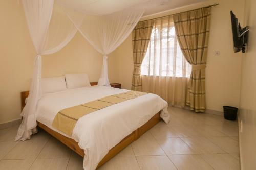 Säng eller sängar i ett rum på Corat Africa Hotel
