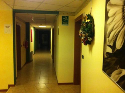 a hallway in a hospital with a wreath on a wall at Ca' Del Bosco in Budòio