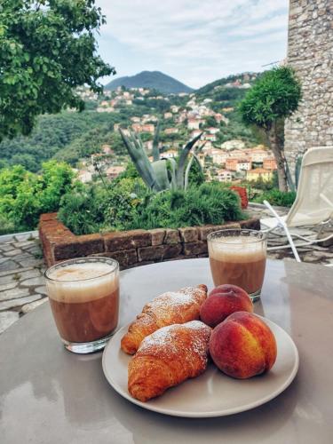 a plate of pastries on a table with two drinks at B.E.A. Maison in La Spezia