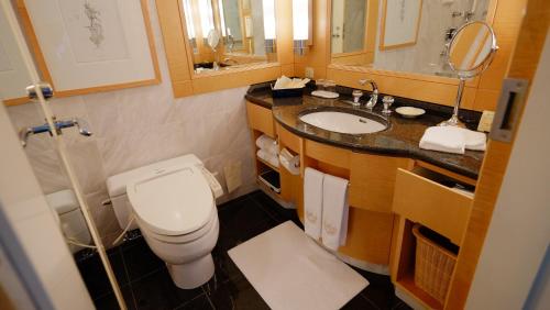 a bathroom with a toilet and a sink at Imperial Hotel Osaka in Osaka