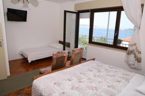 Postel nebo postele na pokoji v ubytování Rooms and Apartments Kurtović