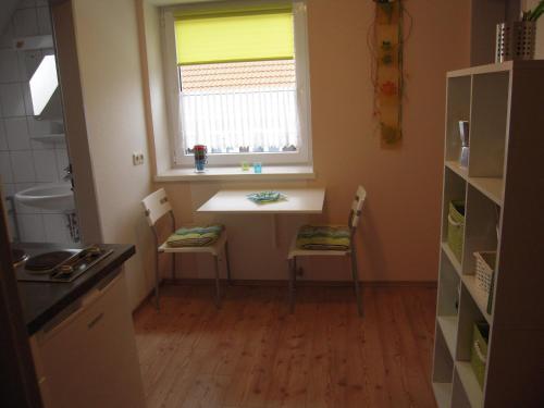 a kitchen with a table and two chairs and a window at Ferienwohnung Briechle in Isny im Allgäu