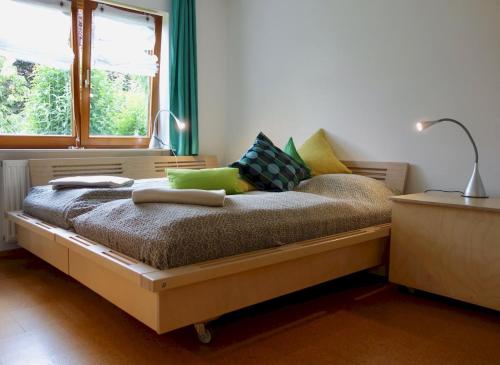 a bedroom with a bed with pillows and a window at Bodenseenahe ruhige Ferienoase in Uhldingen-Mühlhofen