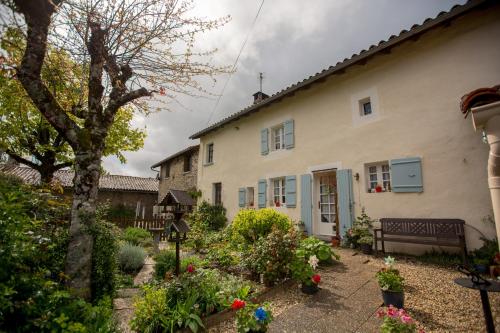 a house with a garden in front of it at La Maison Des Fleurs in Montembœuf