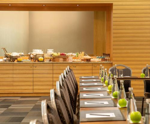 a row of tables and chairs in a room at Radisson Blu Resort & Spa Cesme in Cesme