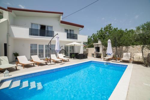 a swimming pool in front of a villa at Villa Sunset in Kastel Novi