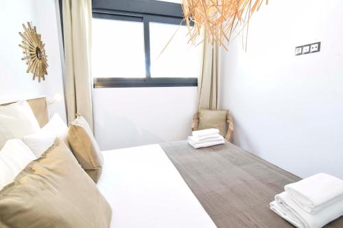 a bedroom with a bed and a window at Letmalaga Carlos Haya in Málaga