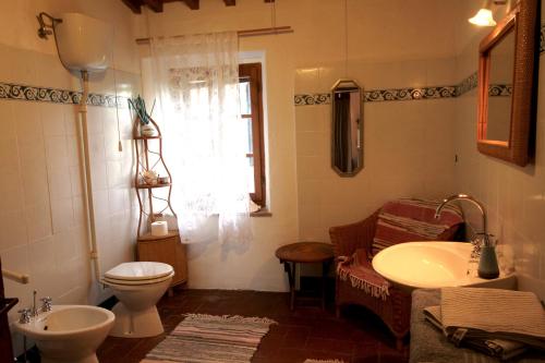 a bathroom with a toilet and a sink at Casina Di Cornia in Castellina in Chianti