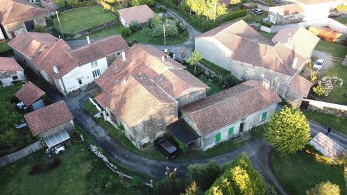 an overhead view of a large house with roofs at La Maison Des Fleurs in Montembœuf