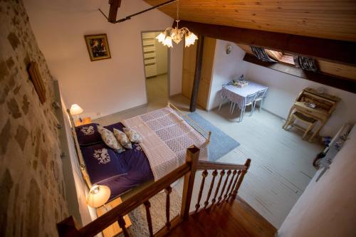 an overhead view of a bedroom with a bed and a table at La Maison Des Fleurs in Montembœuf
