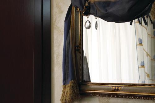 a mirror hanging on a wall next to a window at La Giada in Tivoli