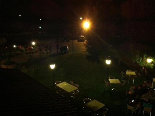 a group of people sitting at tables at night at Ca' Del Bosco in Budòio