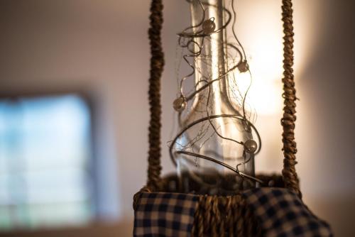 a glass vase is hanging from a rope at Liebe zur Steiermark / Haus Tyrol in Jagerberg