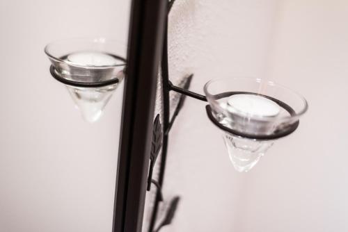 a pair of wine glasses hanging on a window at Liebe zur Steiermark / Haus Tyrol in Jagerberg