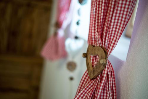a heart shaped pinned to a red and white shirt at Liebe zur Steiermark / Haus Tyrol in Jagerberg