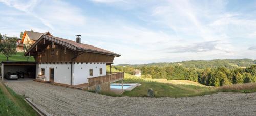a house with a wooden roof and a driveway at Liebe zur Steiermark / Haus Tyrol in Jagerberg