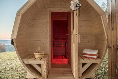 a wooden sauna with a red inside of it at Liebe zur Steiermark / Haus Tyrol in Jagerberg