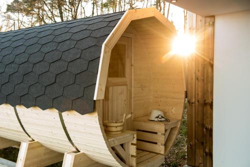 a wooden sauna with a pitched roof at Liebe zur Steiermark / Haus Tyrol in Jagerberg