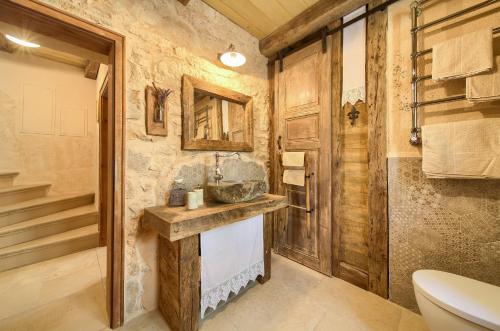 a bathroom with a sink and a toilet at Villa Stone Queen in Malinska