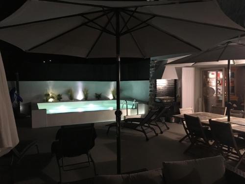 a living room with a fireplace and an umbrella at Villa La Riviera in Mandelieu-la-Napoule