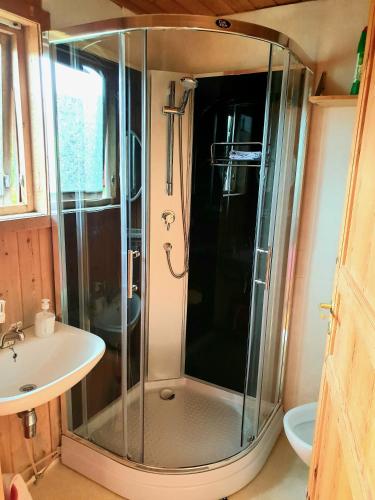 a bathroom with a shower and a sink at Wathne Camping in Bjørheimsbygda