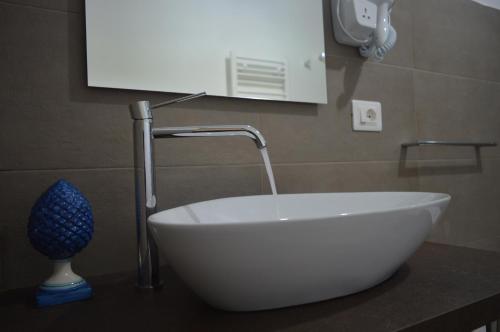 a white sink with a faucet on a bathroom counter at BeB L'ALLORO in Pachino