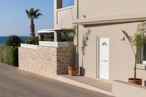 a white house with plants on the side of it at Sea La Vie in Adelianos Kampos