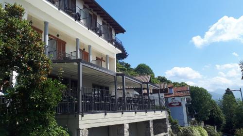 a building with balconies on the side of it at Hotel Sole in Cannero Riviera