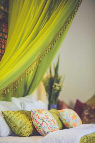 a bed with pillows on it with a canopy at Aathma Colombo House in Colombo